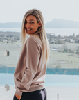 Side view of grey women's crew sweatshirt