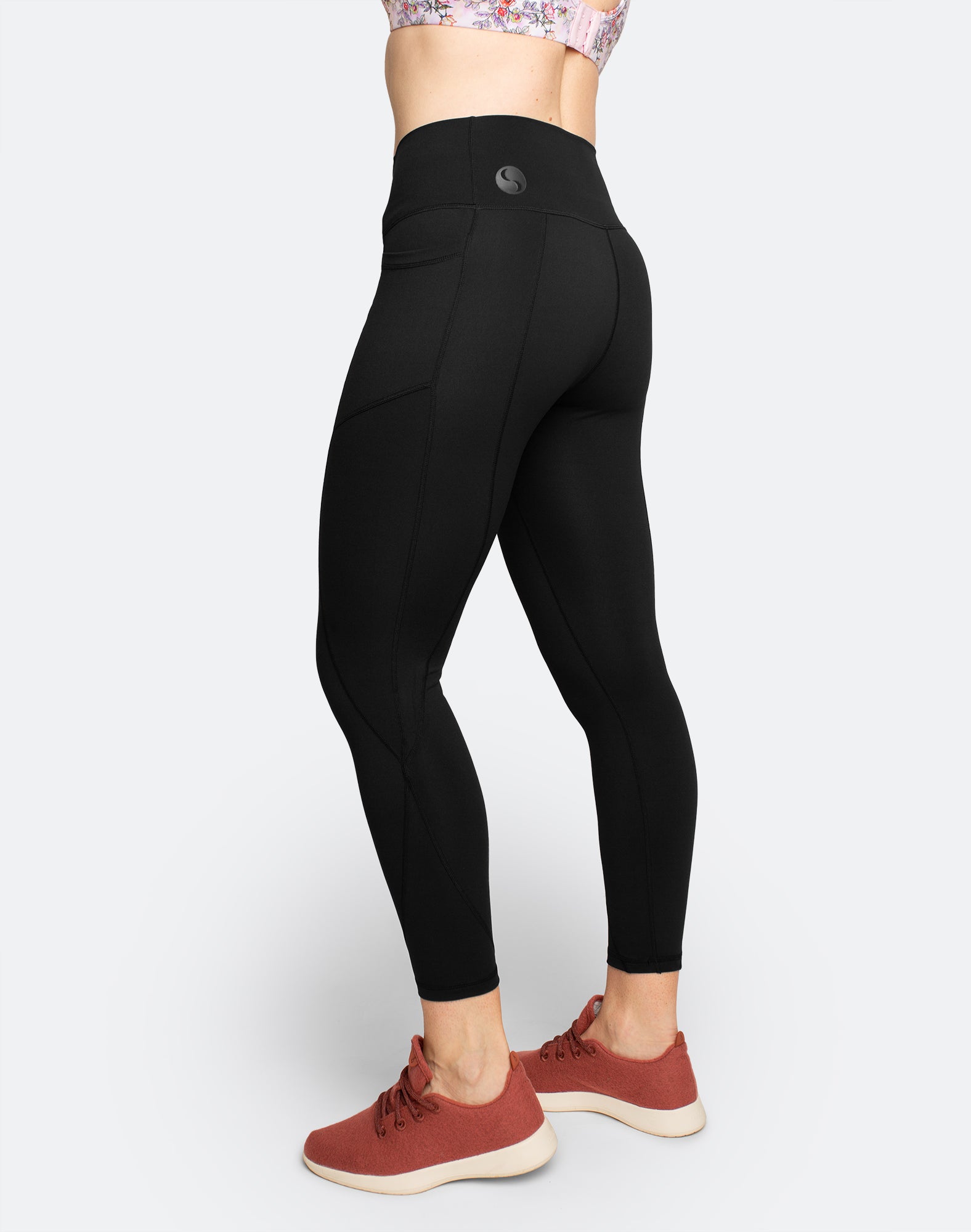 side view of black tights with pocket for phone