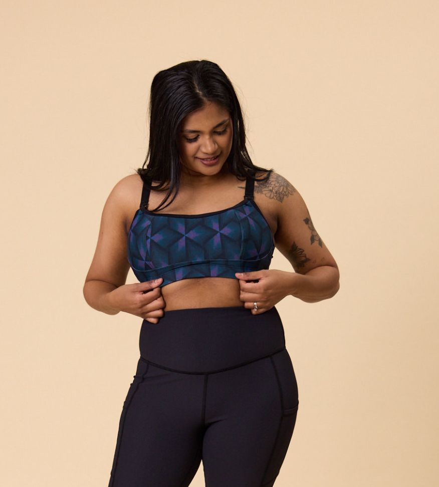 Side view of happy mother wearing high support sports bra